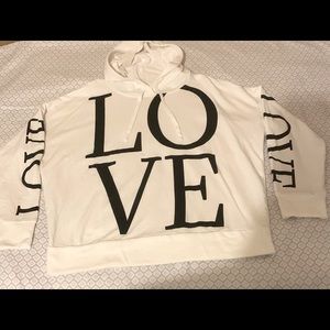 White Pullover Hoodie with “Love” in black on front and on both sleeves.